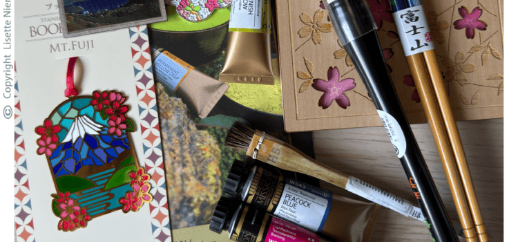 Creative inspiration for surface pattern design showing artist's tools collected during a family trip to South Korea and Japan, including Mijello Mission Gold Class watercolours, traditional Japanese brushes and travel mementos by Lisette Niemand of SassiNiemand.