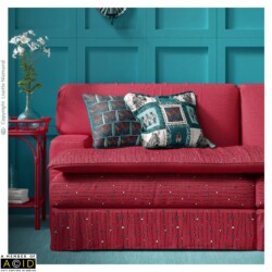 Upholstered sofa and coordinated cushions featuring African Tapestry patterns by Lisette Niemand in peacock blue, magenta and artisan gold tones.