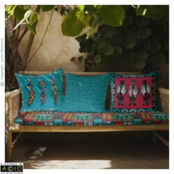 Outdoor courtyard bench featuring coordinated African Tapestry cushions by Lisette Niemand in peacock blue, magenta and artisan gold.