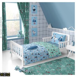Children’s coastal bedroom featuring Seaside Shenanigans bedding and coordinated wallpaper by Lisette Niemand, with humorous seagull sailor characters in a nautical themed interior.