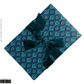 Stationery 2 Luxury wrapping paper design by Lisette Niemand featuring Peacock Indulgence from the Bohemian Spirit Collection, shown with a velvet ribbon bow. Features repeating peacock feather motifs in rich teal, emerald, and magenta tones.